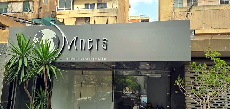 The Mnets office in Zalka, with the Mnets sign above the glass entrance
